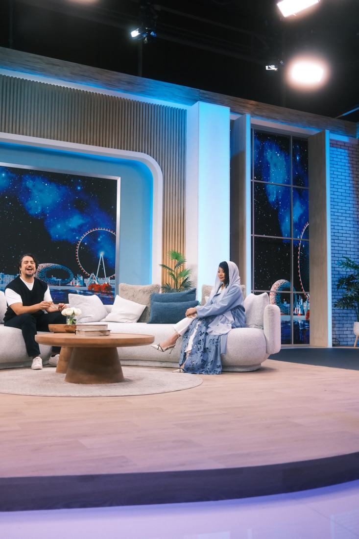 Dua on the studio set in a pale blue abaya