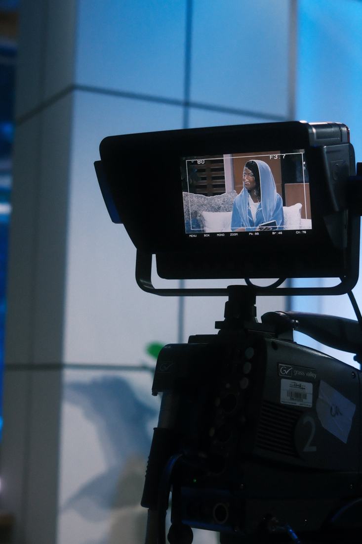 Dua framed in a studio camera viewfinder