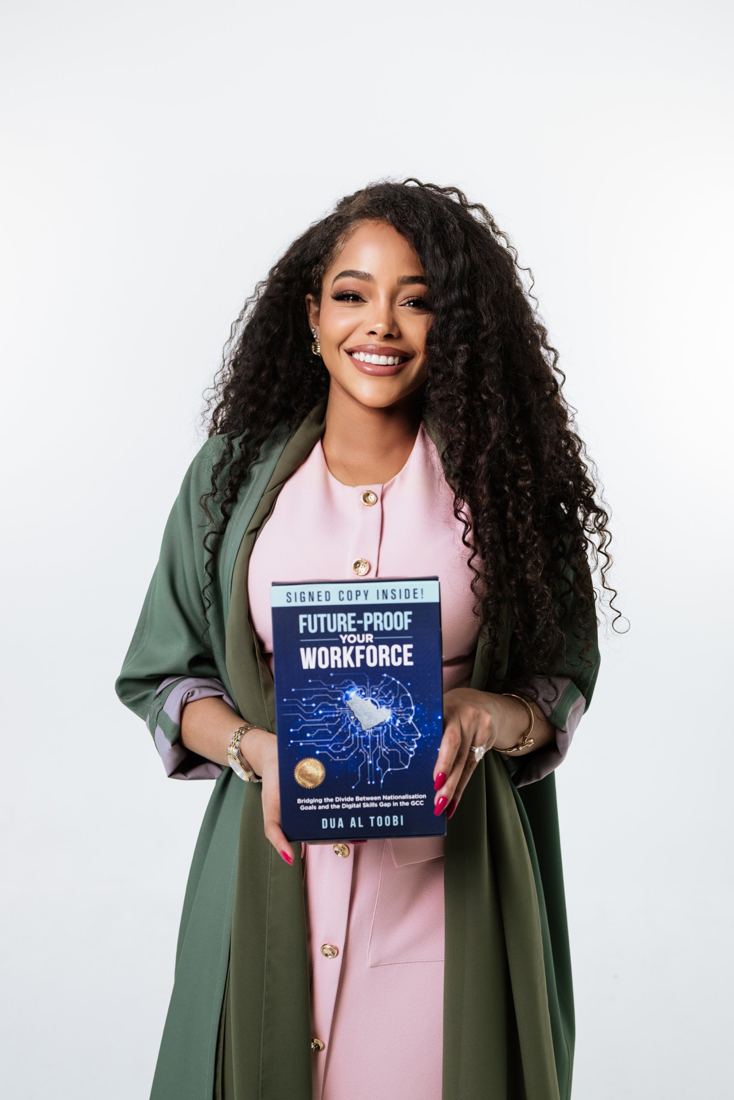 Dua Al Toobi holding a signed copy of Future-Proof Your Workforce